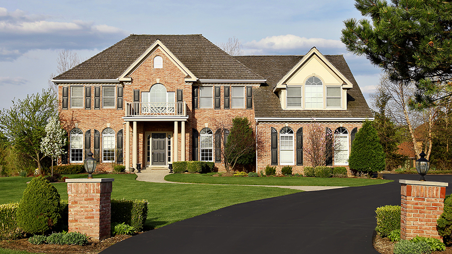 Exterior of a luxury brick home during a home inspection