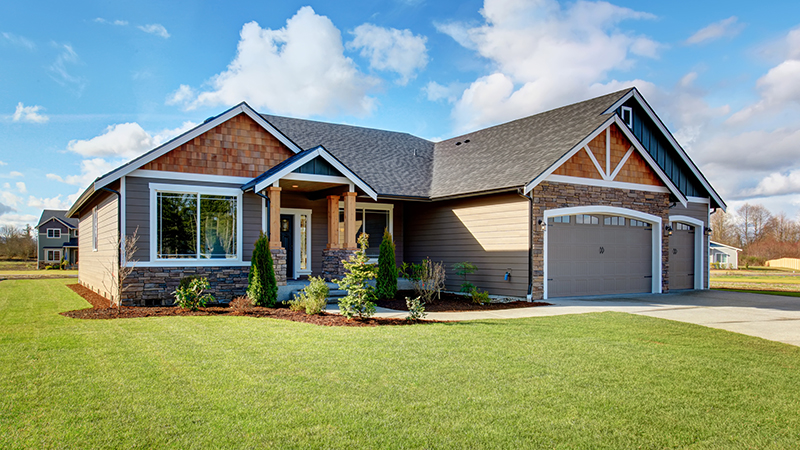 Newly constructed house with walkway and lots of grass after receiving home inspection services