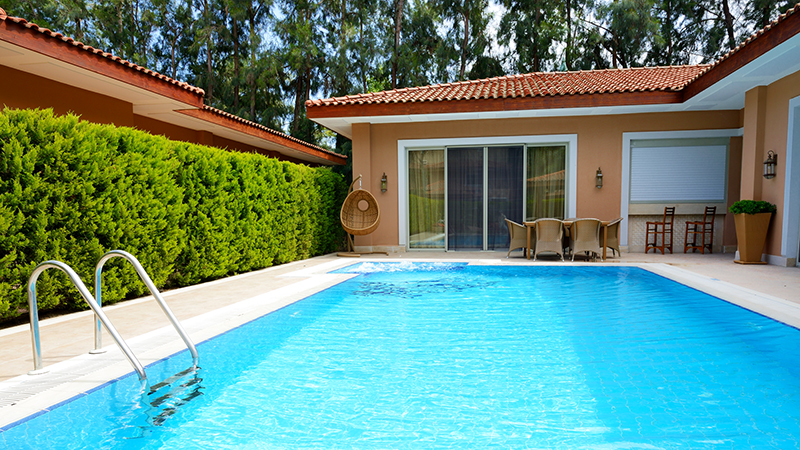 Swimming pool behind a residential home photographed while receiving home inspection services